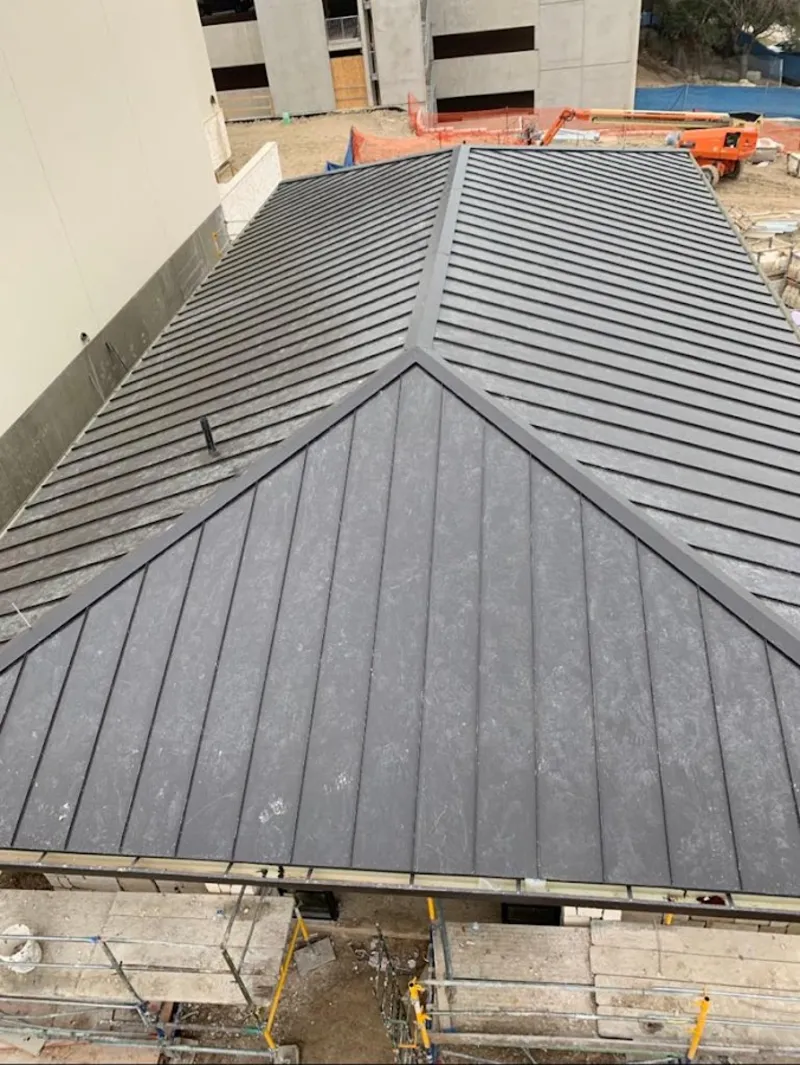 Commercial metal roof construction with crane equipment in South Whitehall